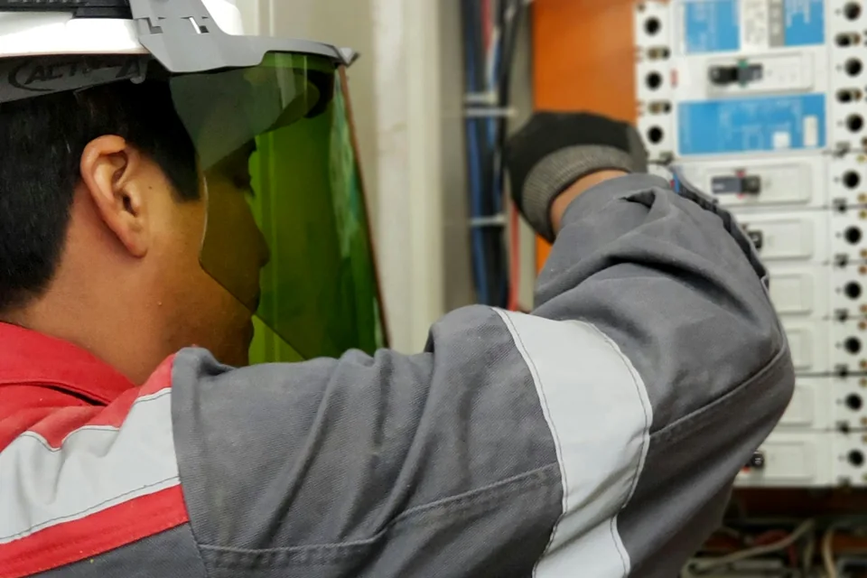 Stock concept image of an electrician working at an electrical panel